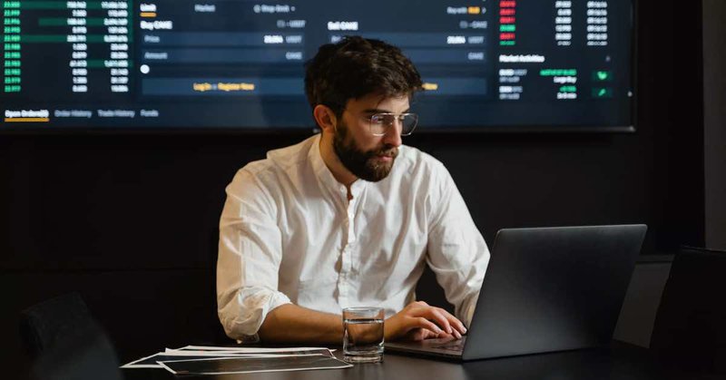 man-at-desk-looking-at-data-governance-document-on-laptop